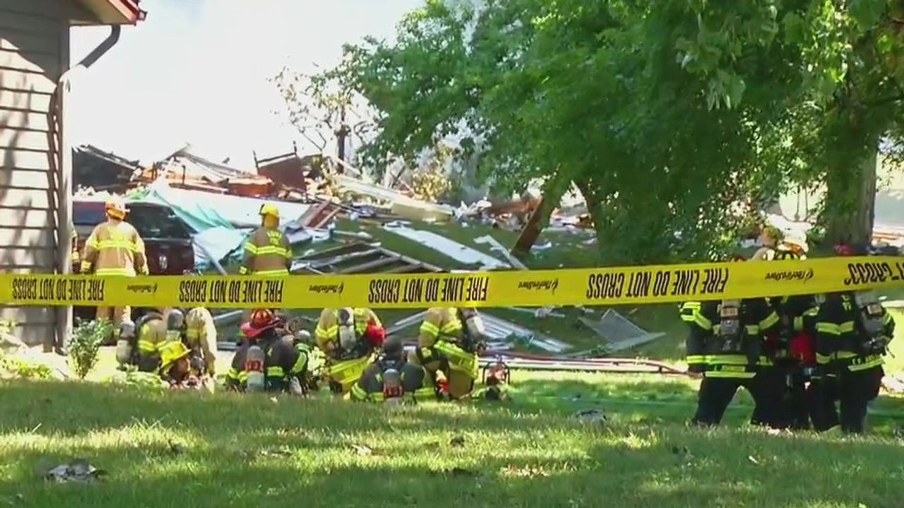 Police tape surrounds the scene of a home explosion in Hopkins, Minn.