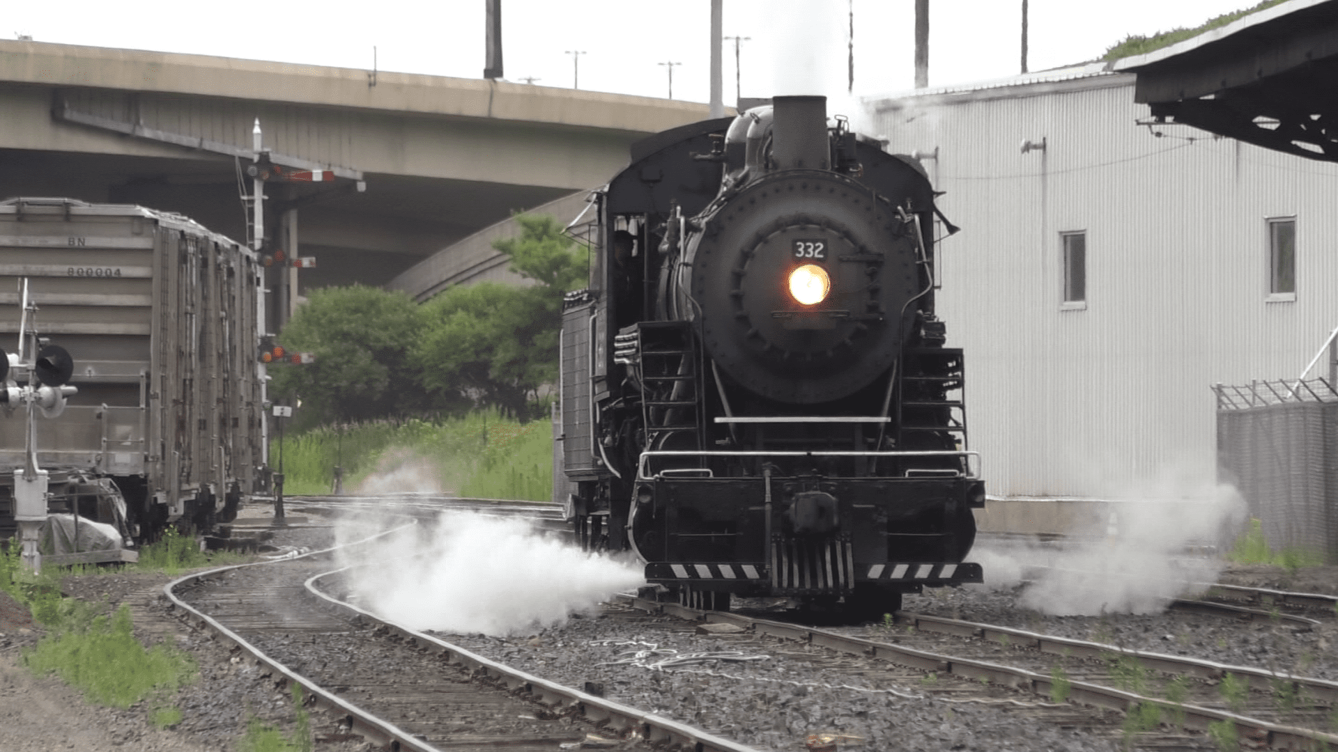A steam locomotive on the railroad tracks