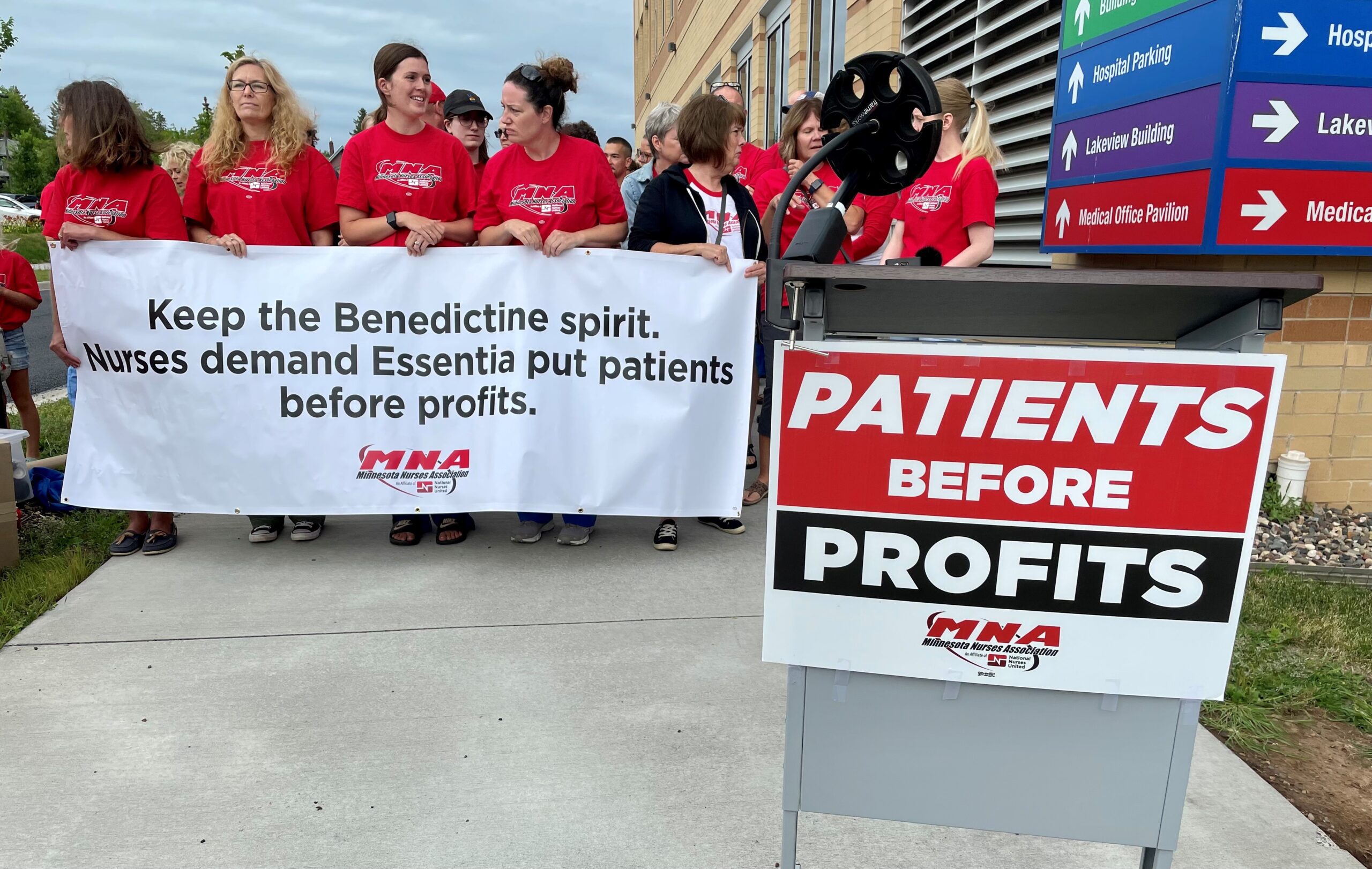 Union nurses hold a banner