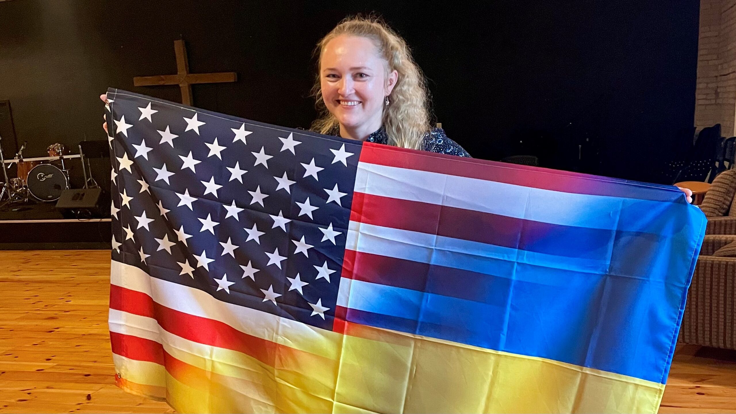 Galyna Tuttle holds a flag that is half American, half Ukrainian