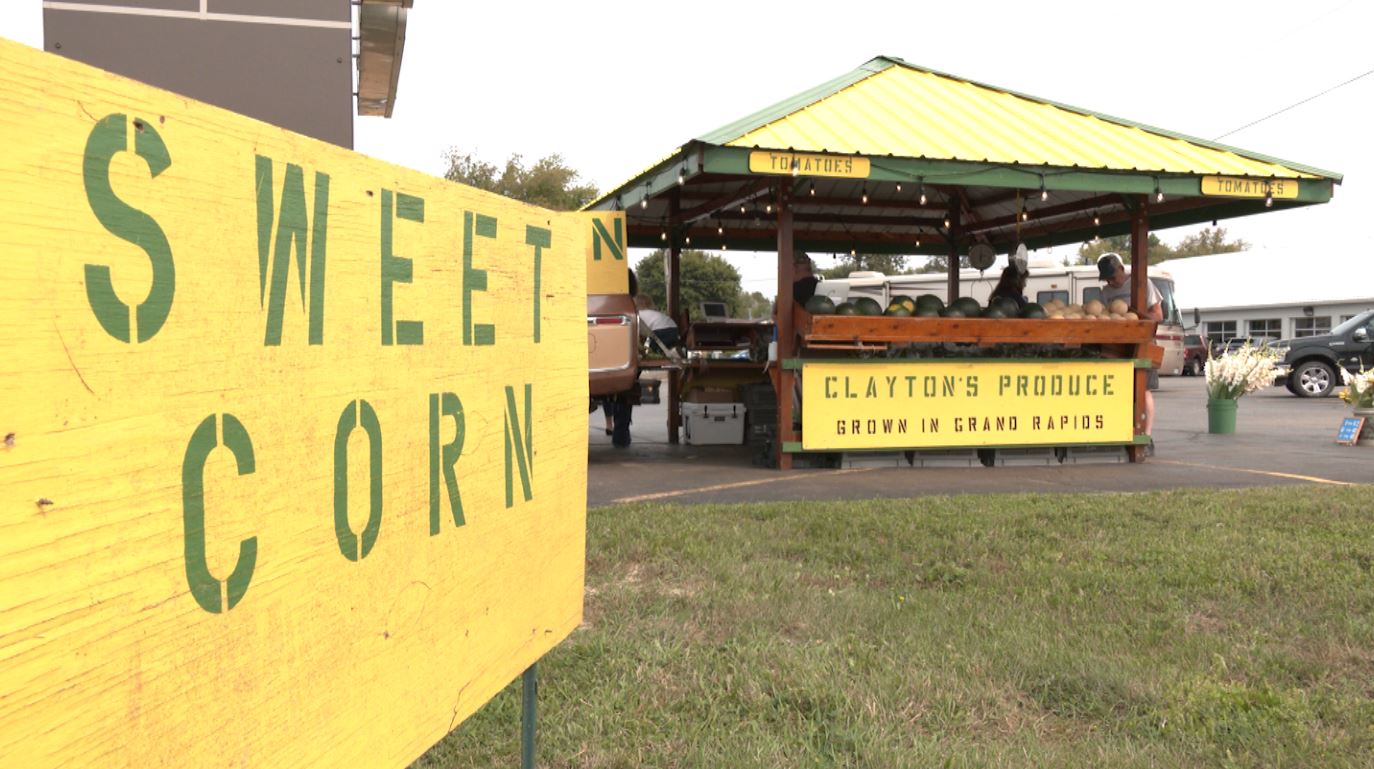A sign advertises sweet corn outside Clayton's Produce Stand