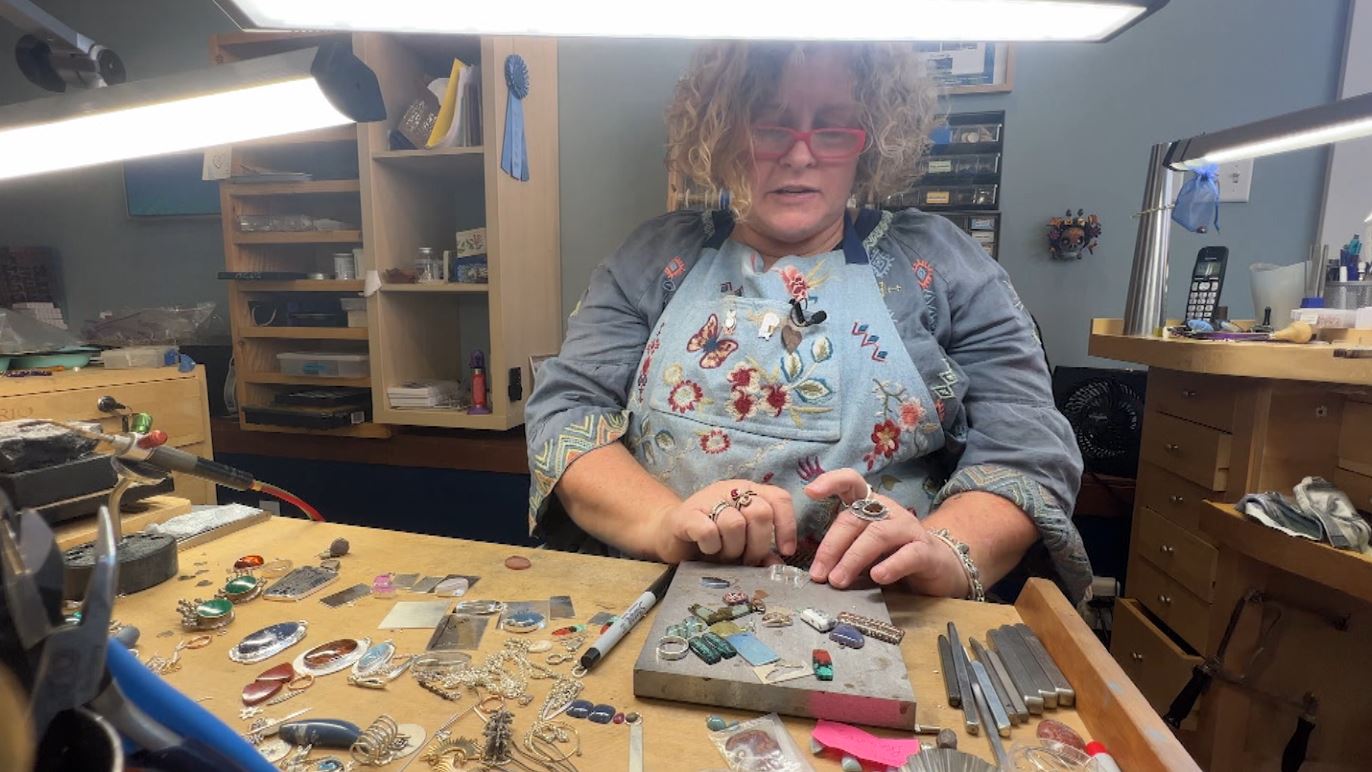 Lissa Fleming works on a piece of jewelry in her gallery
