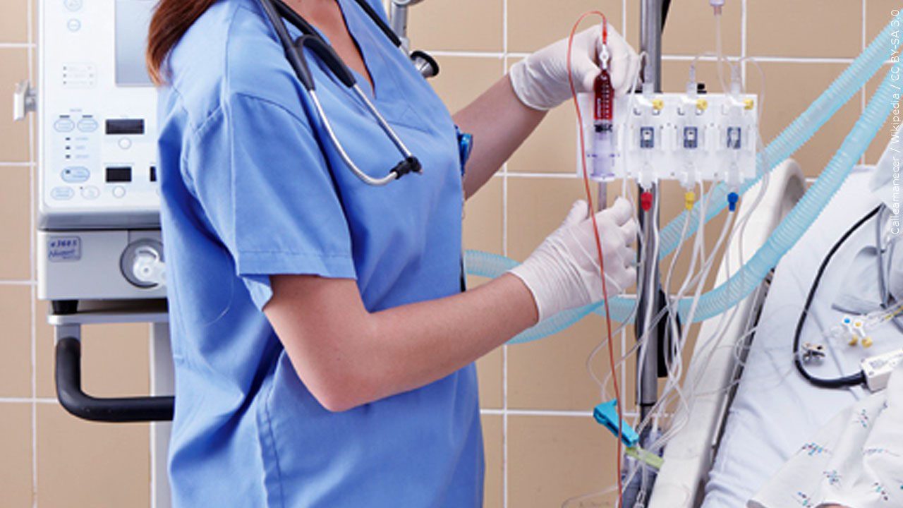 Female nurse at the bedside in the ICU