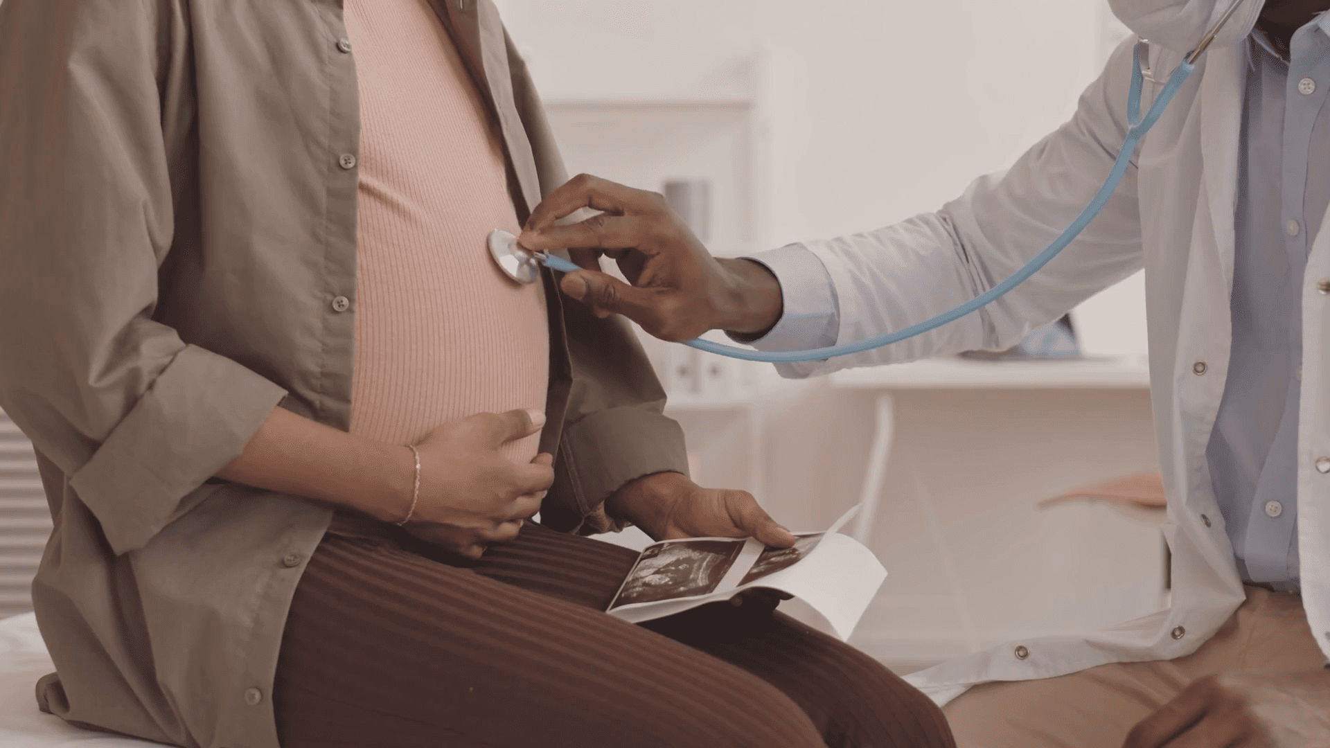 A doctor checking a woman's stomach