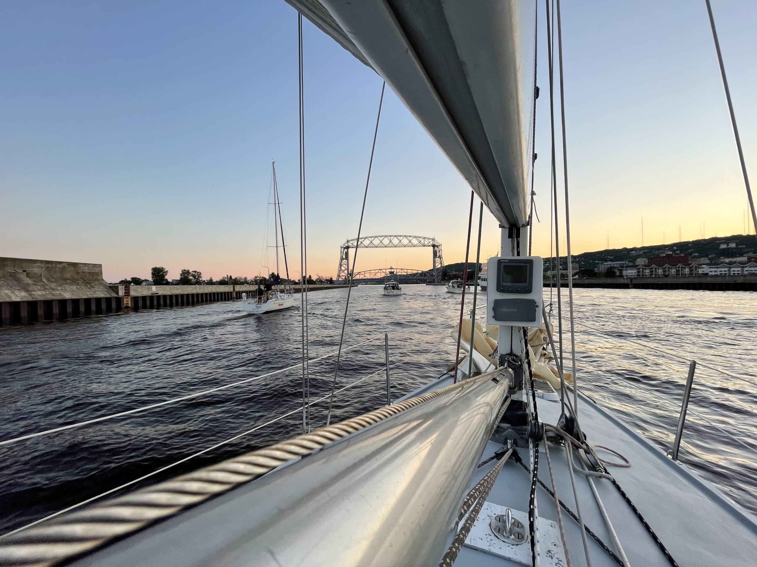 The bow of a sailboat heading toward the Lift Bridge