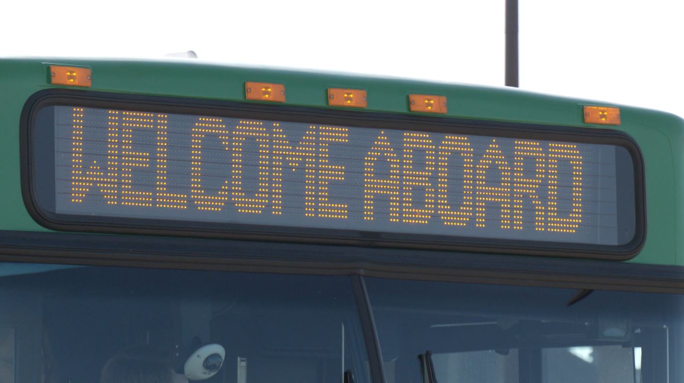 A sign on a DTA bus says, "Welcome Aboard."