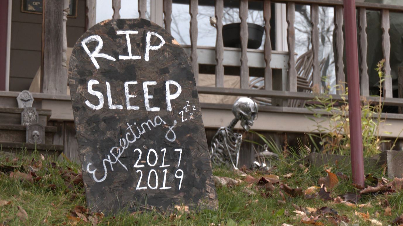 A yard decoration says "RIP sleep"
