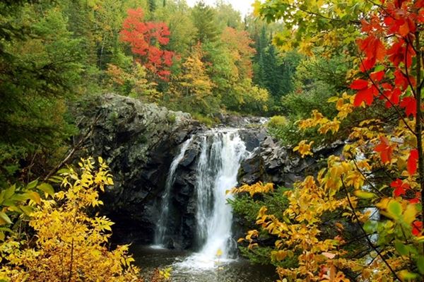 waterfalls with red, yellow and orange leaves