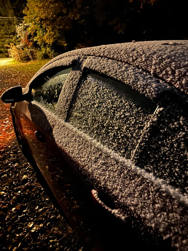 snow coats a car on October 7