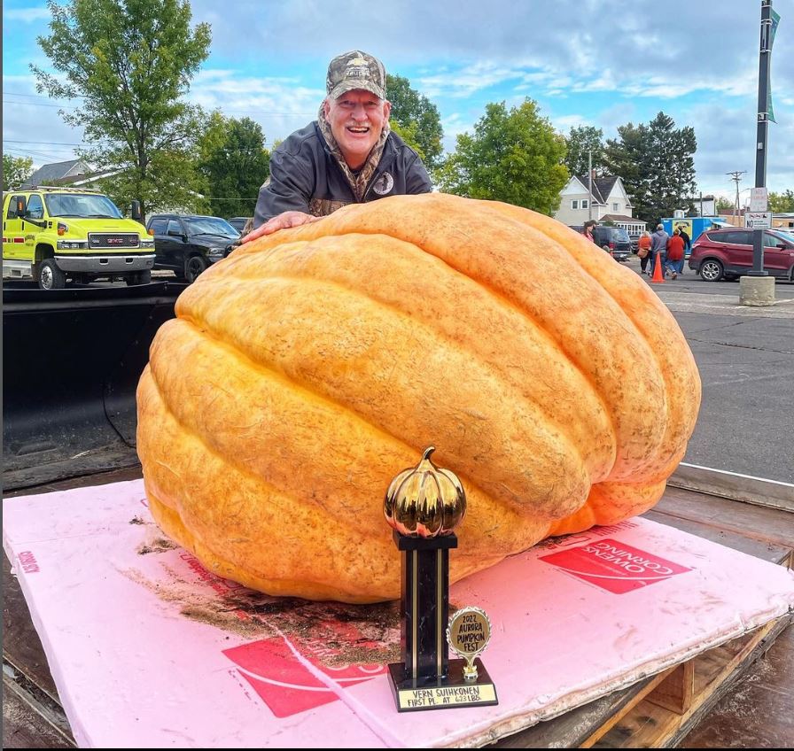 farmer behind 623 pound pumpkin at Pumpkin Fest