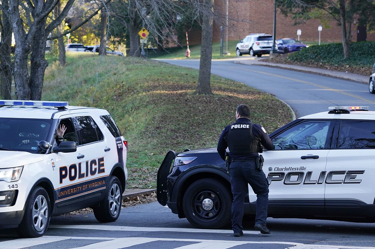 Two Charlottesville police vehicles secure a crime scene after a shooting at the University of Virginia on Nov. 14, 2022