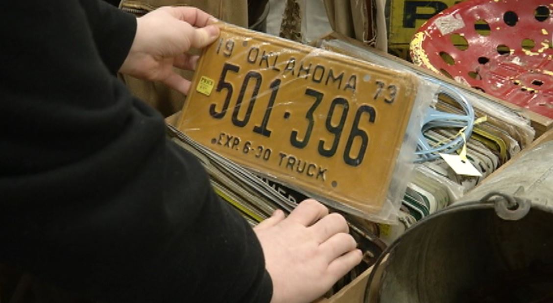 Someone looks at old license plates