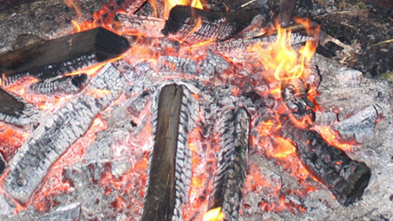 large fire pit with embers and flames