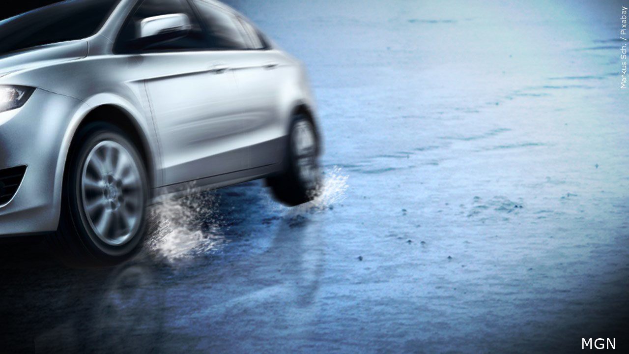 Grey car slips off icy roadway