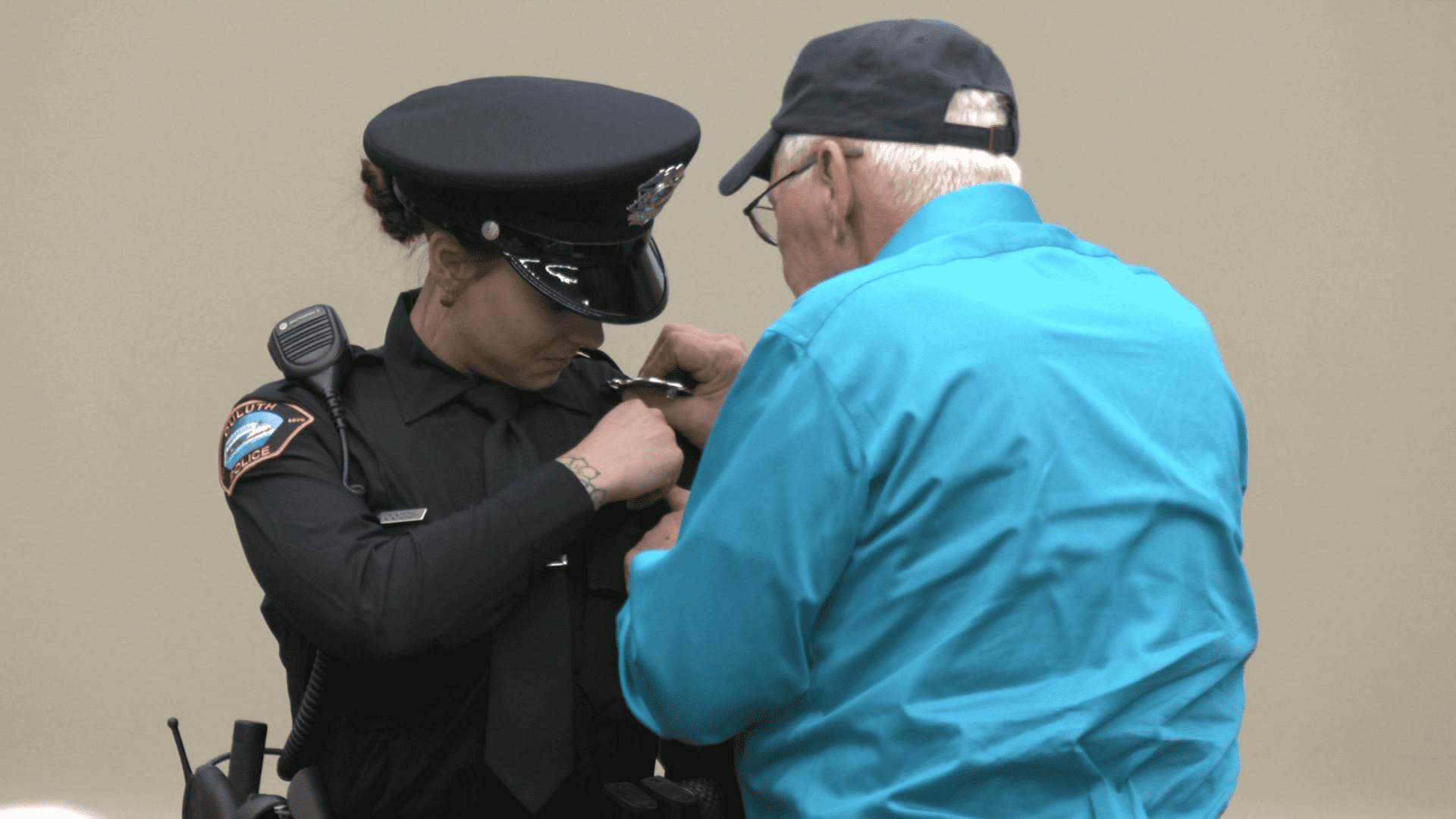 image of badge being pinned on police officer