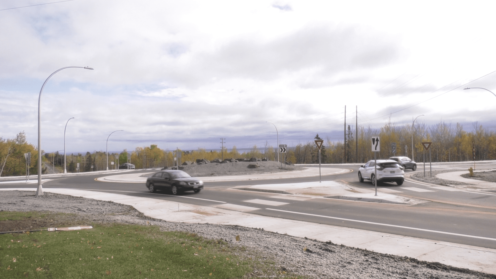 Picture of roundabout constructed at Glenwood St. and Snively Road in Duluth. Lake Superior in background.