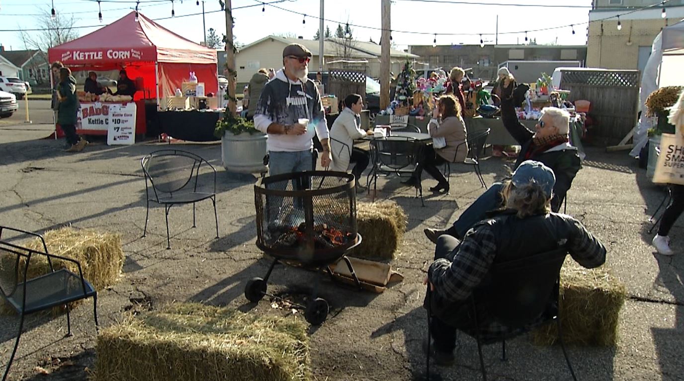 People sit around a bonfire at the Thirsty Pagan's Holiday Market