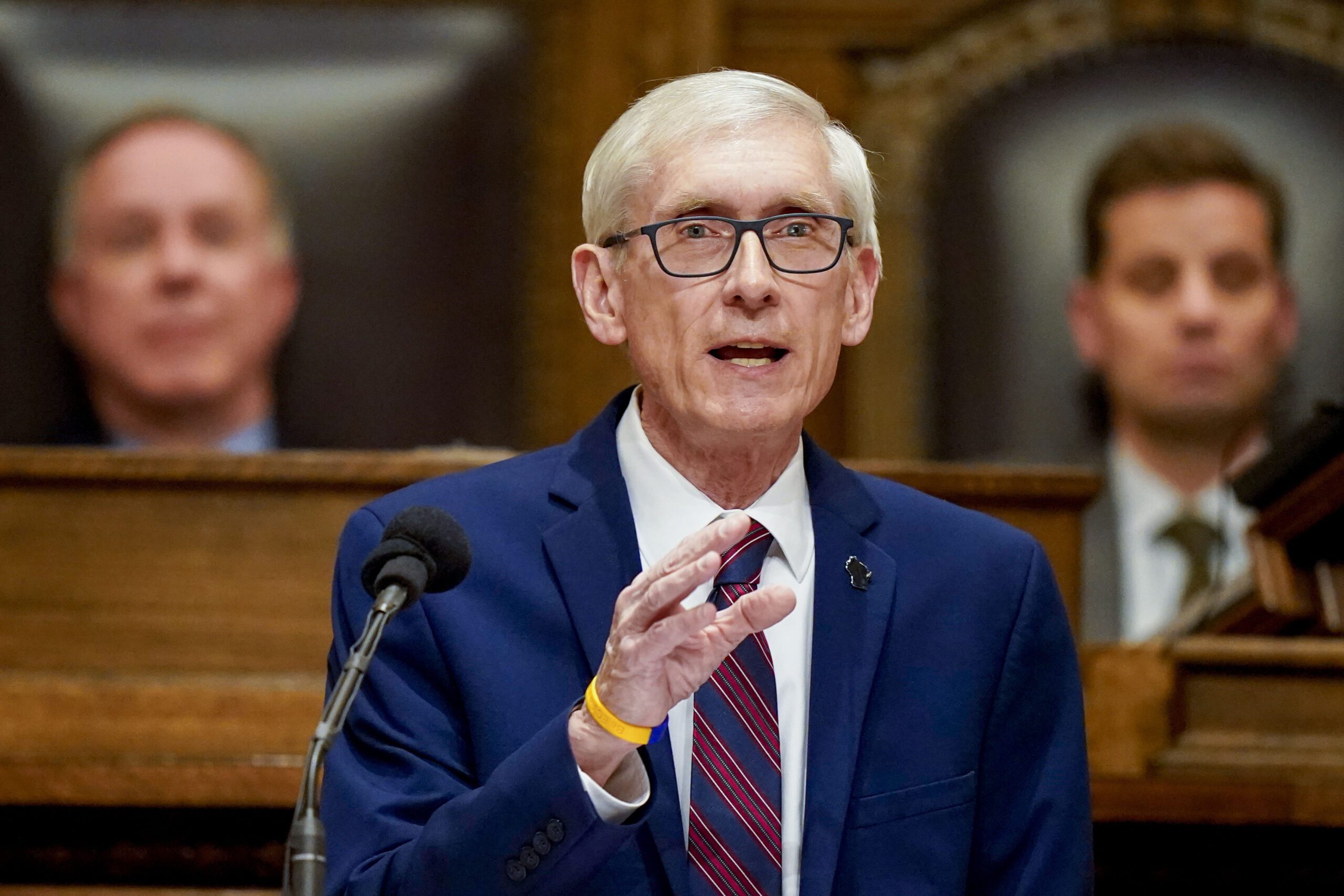 Wisconsin Gov. Tony Evers speaking behind a podium.