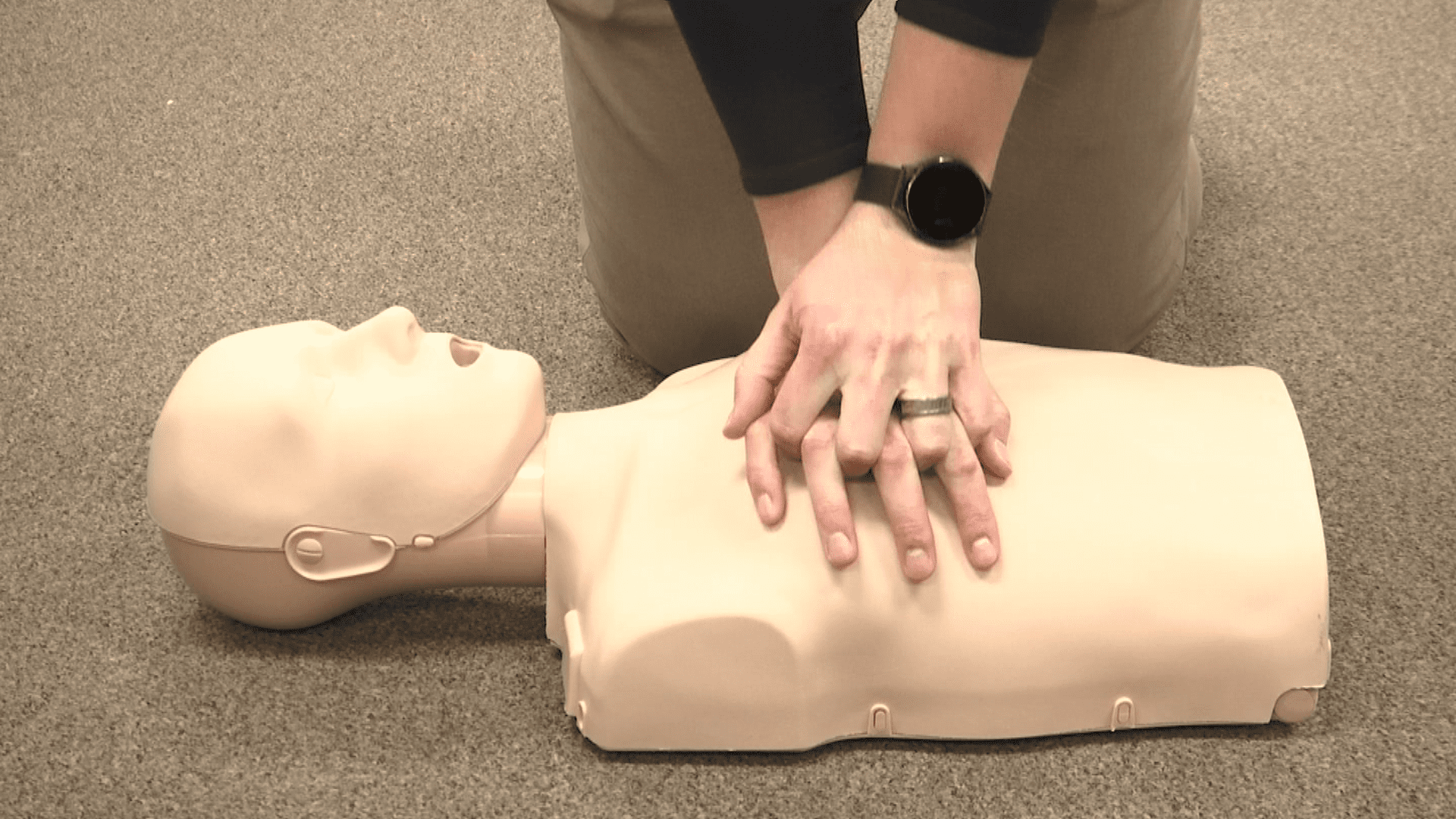 photo of person giving CPR to practice dummy