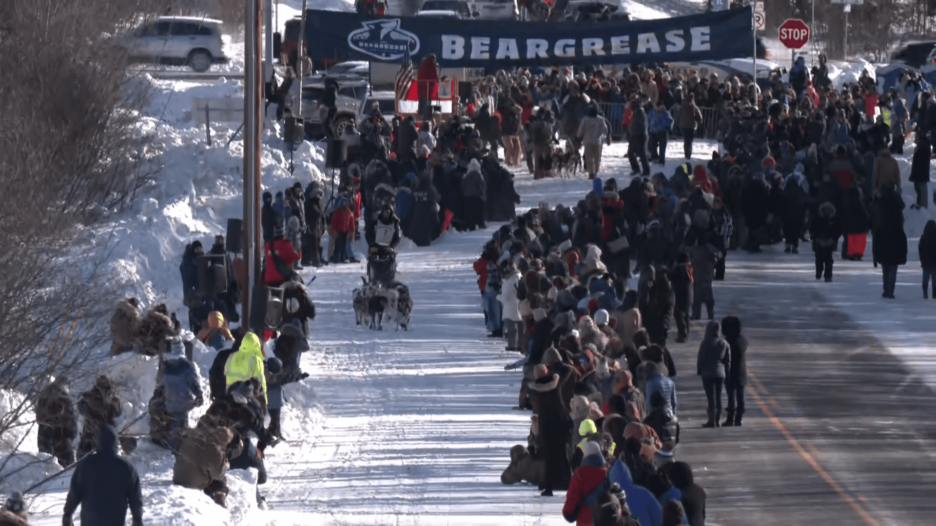 Wide shot of the starting chute with Ryan Anderson's team and lots of people around.