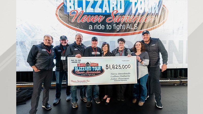 People with the Blizzard Tour hold a big check