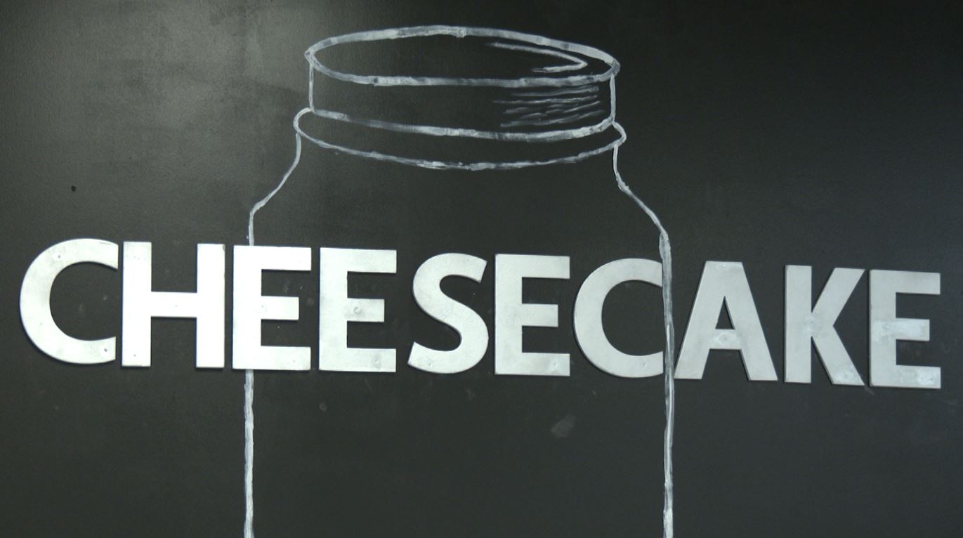 A big "Cheesecake" sign on a wall