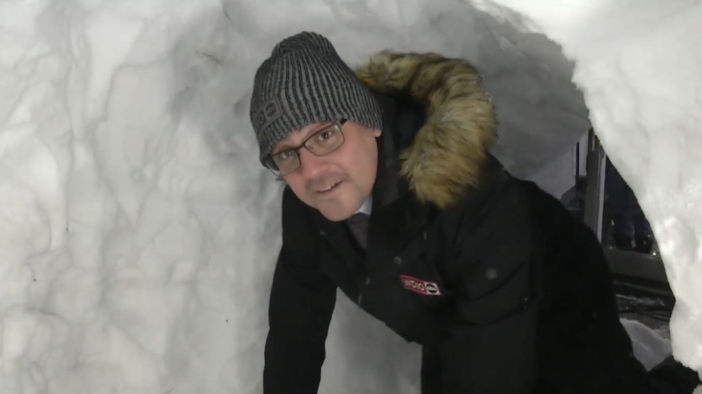 Justin Liles crawls into a snow fort