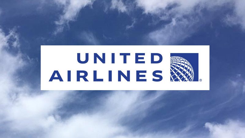 United Airlines blue logo over cloud-filled sky.