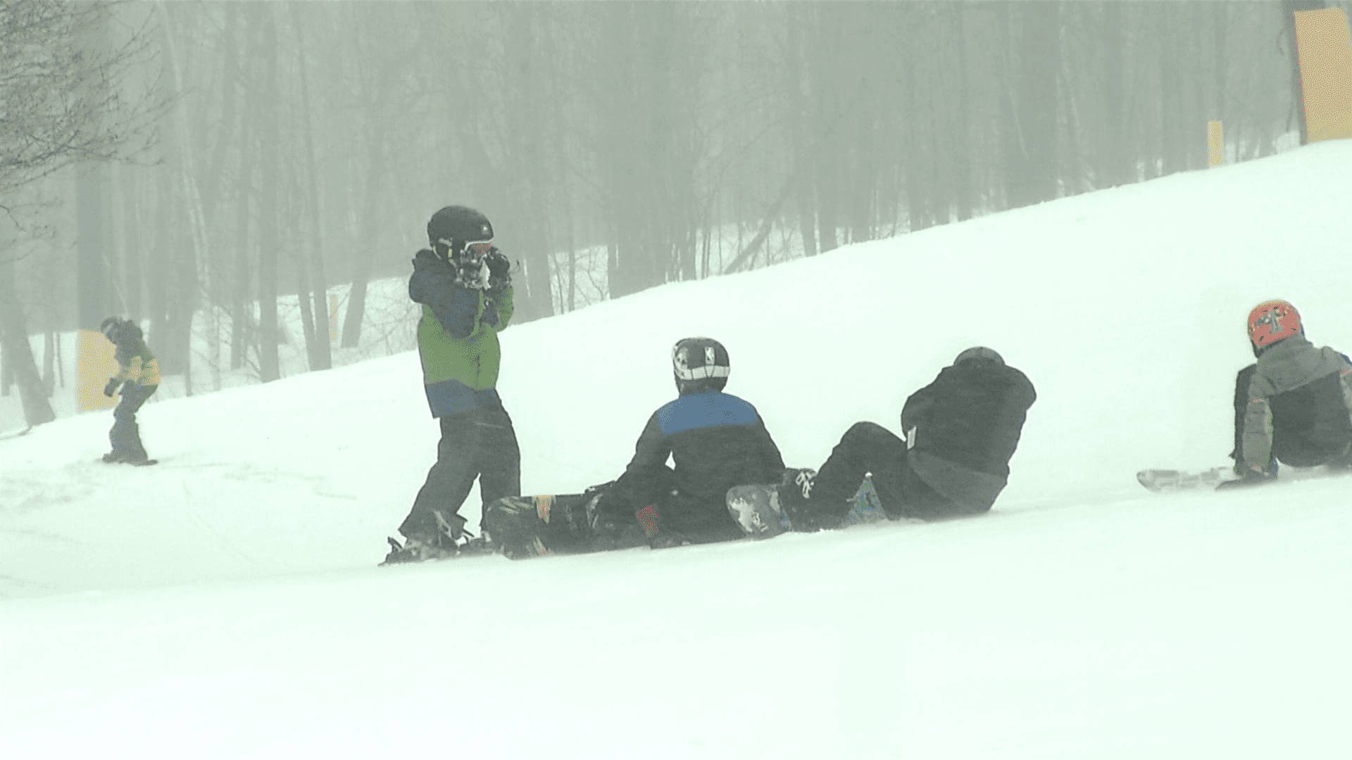 People snow boarding on the slopes.