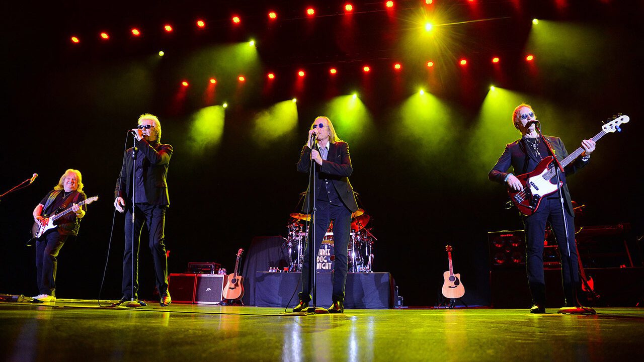 The band Three Dog Night on stage with yellow haze and lights.