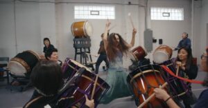 A woman drumming in the film "Finding Her Beat"
