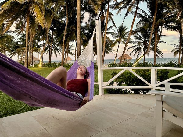 Baihly Warfield smiles while sitting in a hammock in Belize.