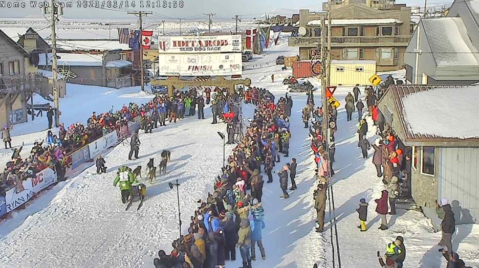 Ryan Redington and his dog team approach the burled arch finish line in Nome.