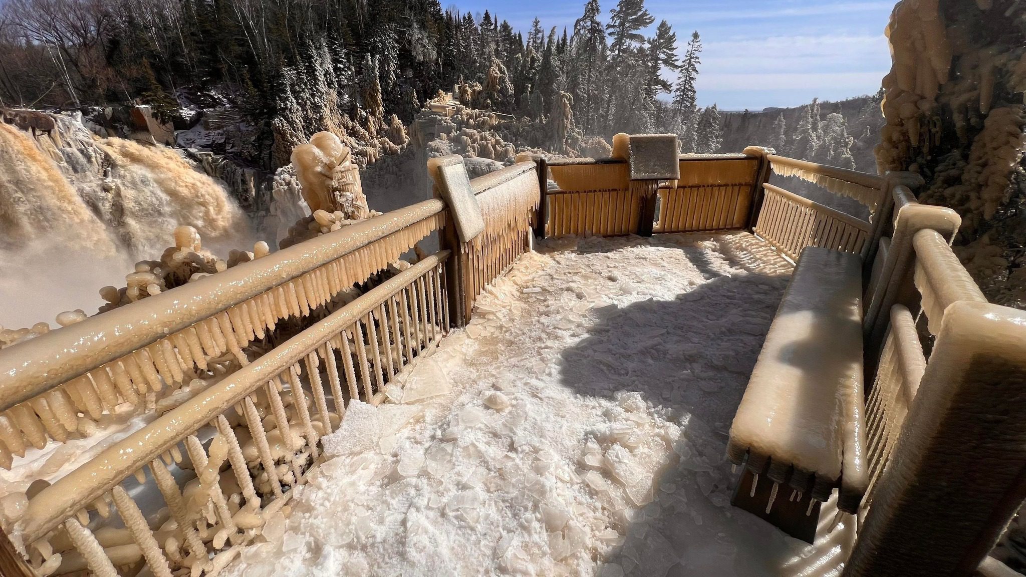 The High Falls viewing platform at Grand Portage State Park is coated in ice.