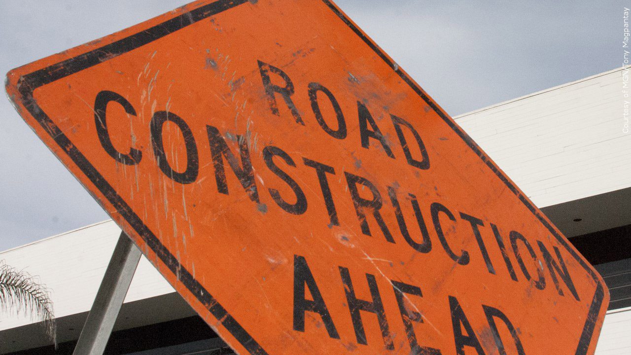 Road construction ahead orange sign.