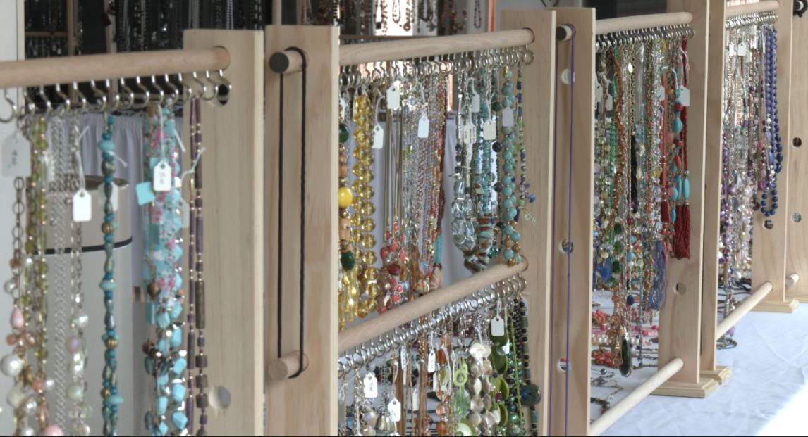 Racks of necklaces hang at the Benedictine jewelry sale