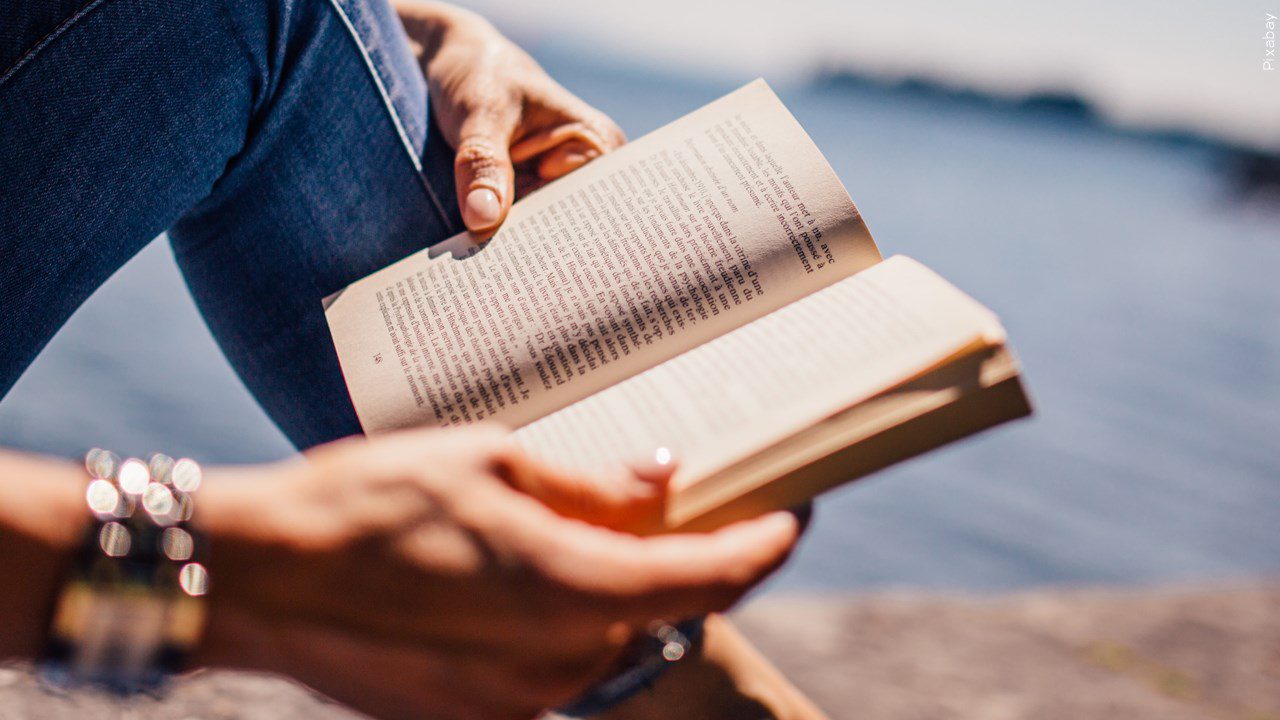 A person reading a book outside