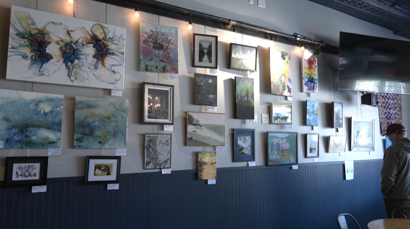A gallery wall of art from the Voyageur Artists