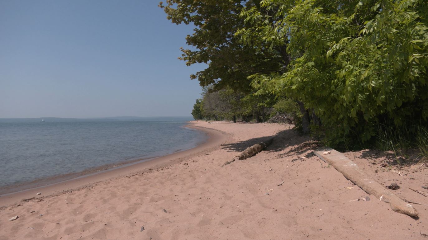 The sun shines on a quiet beach on Madeline Island