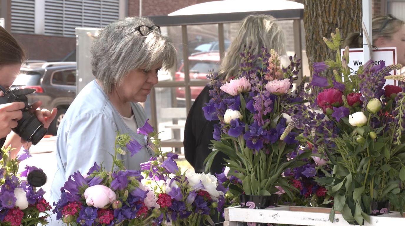A woman shops for flowers at Duluth's Hillside Farmer's Market
