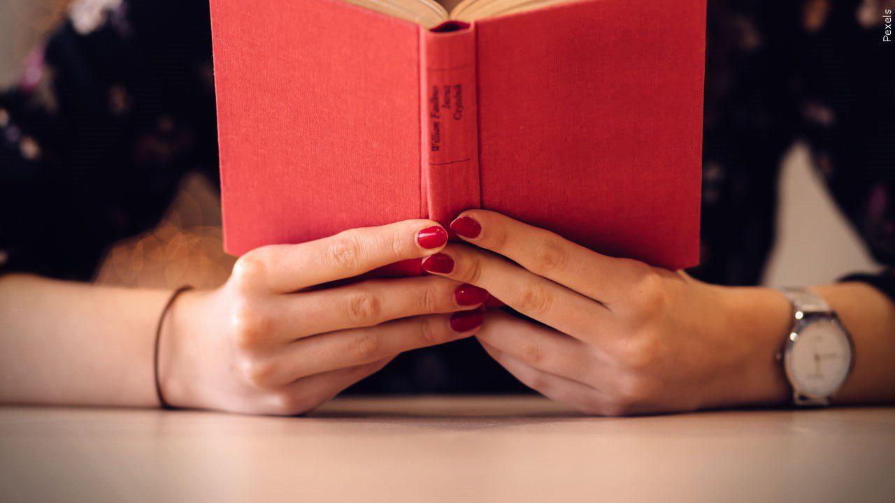 A person reads at a desk