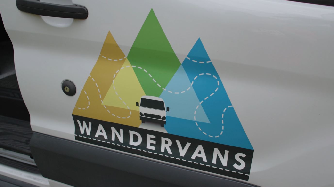 The logo on the side of a Wandervan