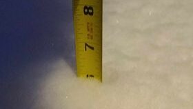 Ruler in snow marking six inches