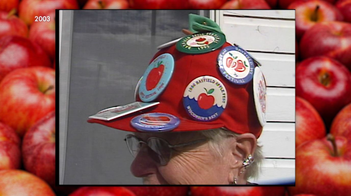 A woman's pin-covered hat at the Bayfield Apple Festival in 2003