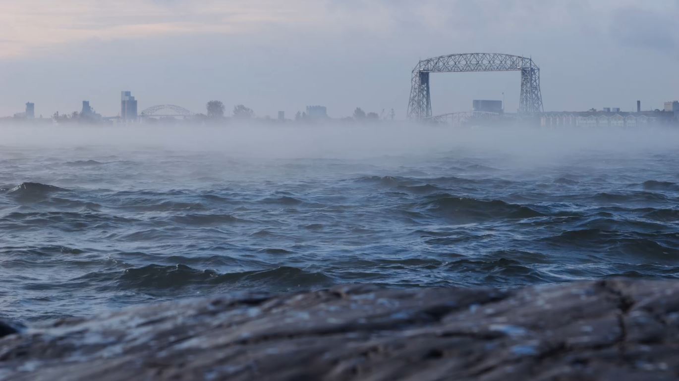 Sea smoke hovers over the surface of Lake Superior