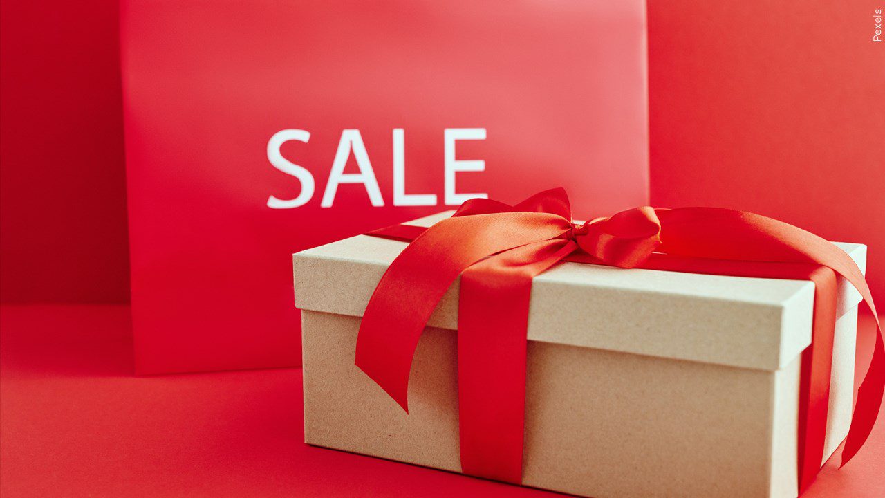 A sale sign with a holiday box