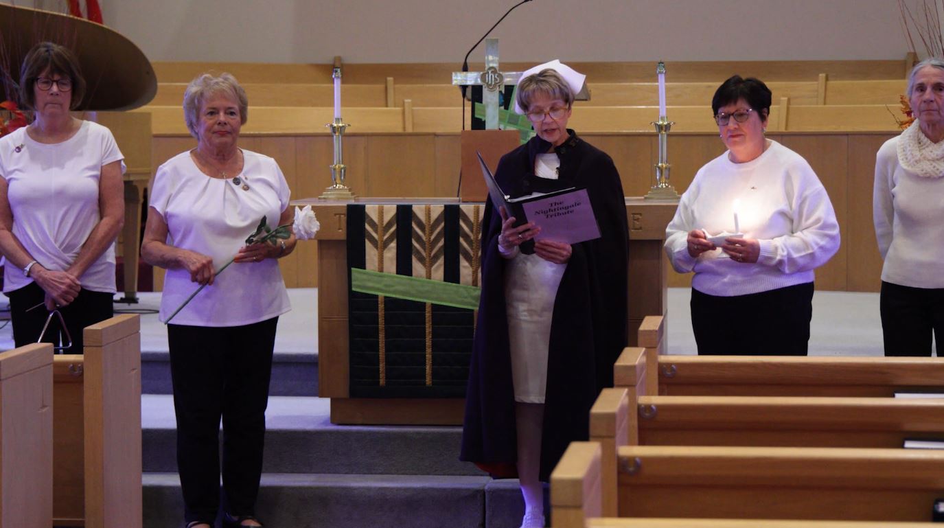Pam Franklin and volunteers from the Nurse Honor Guard offer a mock tribute.