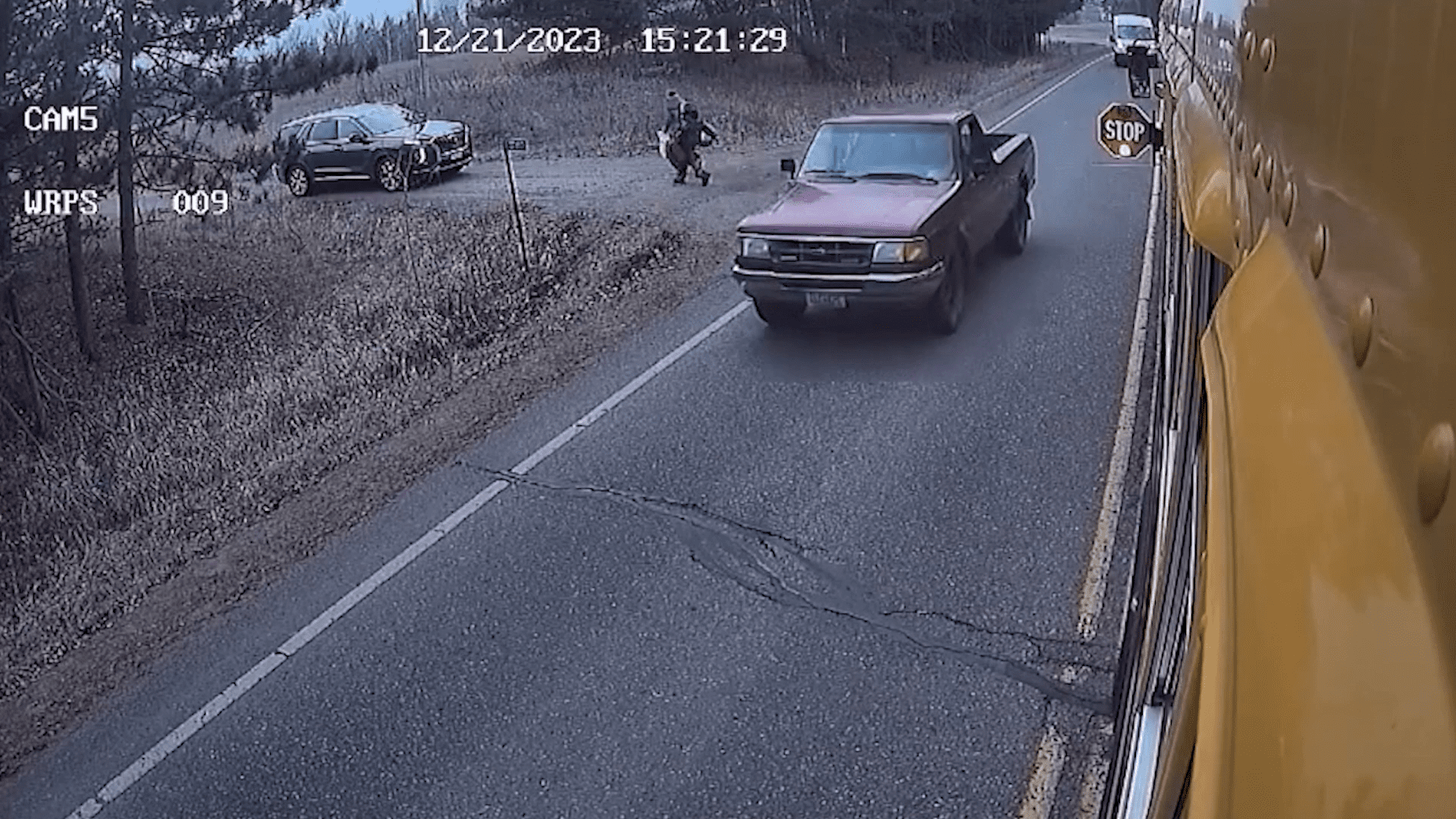 Truck almost hits kids getting off the bus.