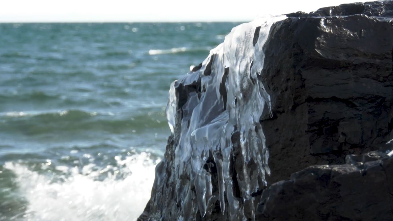 Ice clings to a rock along the Lake Superior shoreline