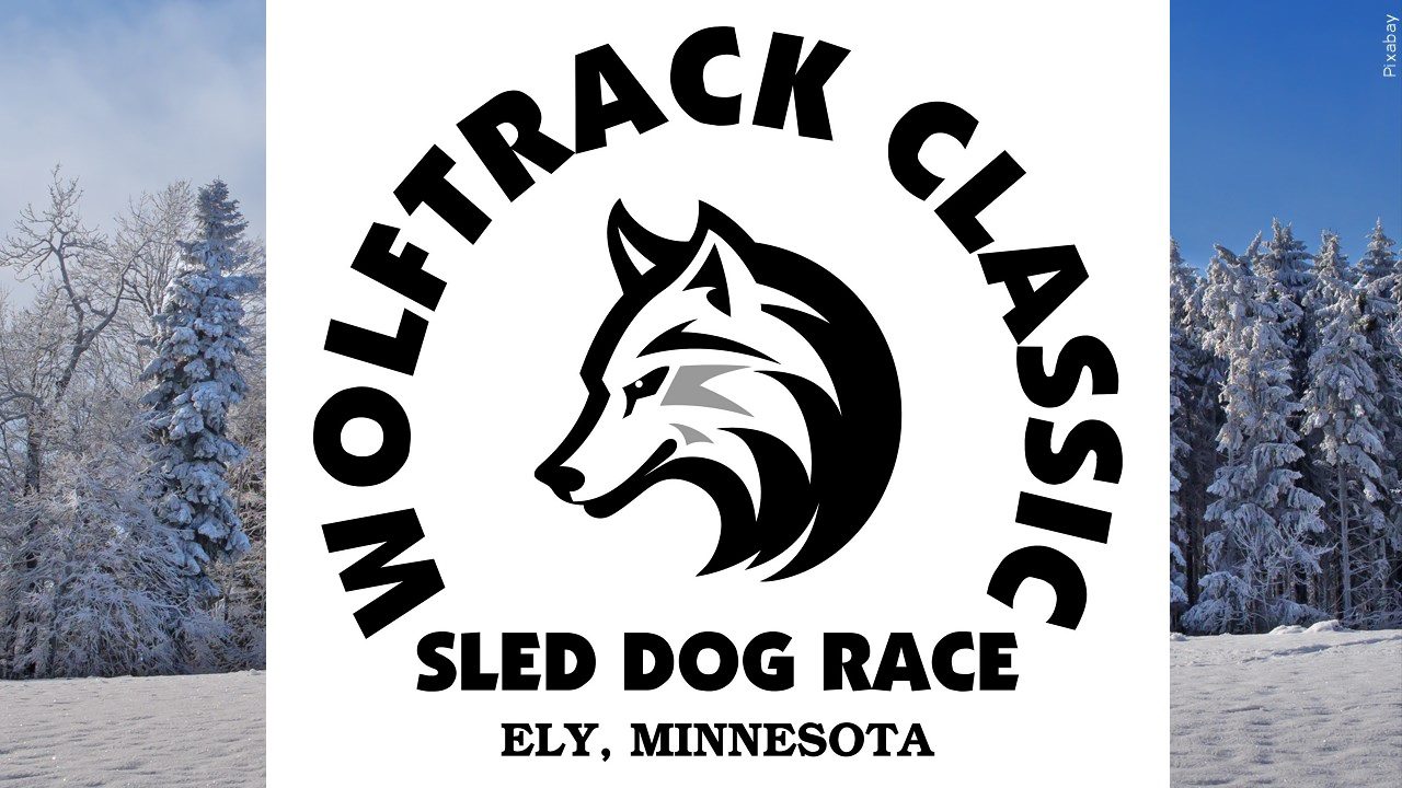 The Wolf Track Classic logo on a background of snowy trees